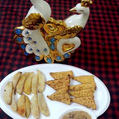 A picture of Nachos & French fries with cheese fudge.