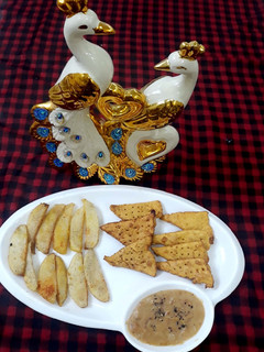 A picture of Nachos & French fries with cheese fudge.