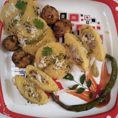 A picture of Dhokla in idli version stuffed with cheezee rice patty.