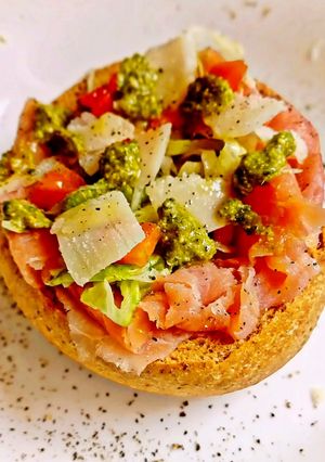 A picture of Fresella Basket with Smoked Salmon, Iceberg Lettuce, Pesto Genovese, Pecorino, and Fresh Vegetables.