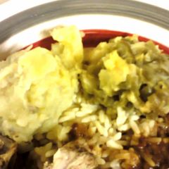 A picture of Mashed potatoes with green beans.