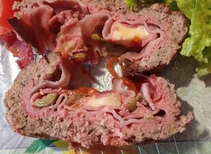 Una foto de Pan de carne relleno de panceta, jamón, queso, morrón y aceitunas
