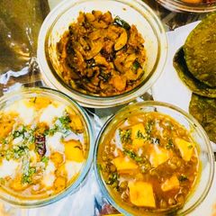 A picture of Potatoes butter Masala,Mutter Paneer,Khatta meetha Kaddu with Spinach Poori.