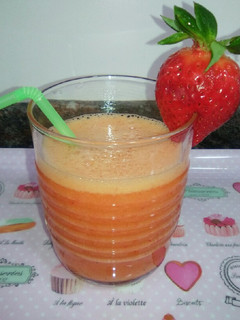 Una foto de Zumo de naranja y fresas