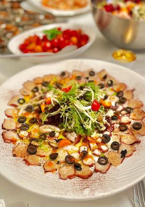 A picture of Octopus Carpaccio in extra virgin oil oil and paprika powder.