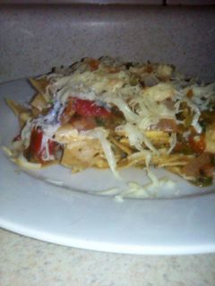 A picture of Tortilla Chips with Eggs and Ranchera Sauce.