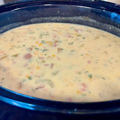 A picture of Corn chowder with ham or bacon.