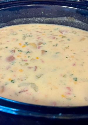 A picture of Corn chowder with ham or bacon.