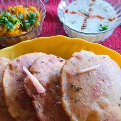 A picture of Jau alu Puri with pethe ki sabzi with raita.