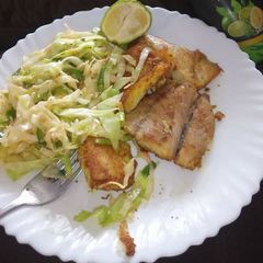 A picture of Fried fish fillet and fries cabbages.