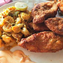 A picture of Crispy fried fish with stir fry prawns and dip.