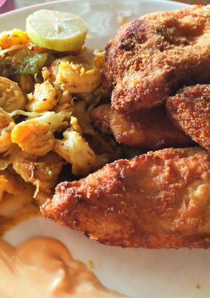A picture of Crispy fried fish with stir fry prawns and dip.