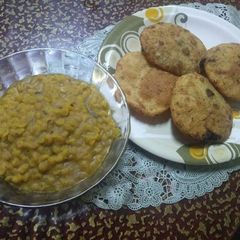 A picture of Karaisutir kachuri and mishti cholar daal.