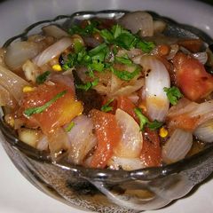 A picture of Roasted onion and tomato salad.