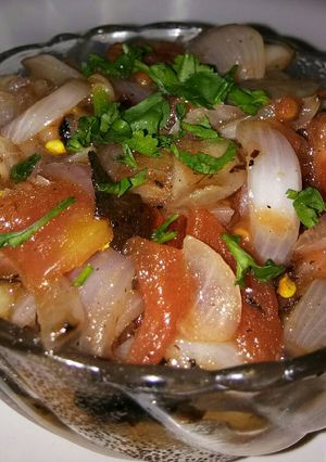A picture of Roasted onion and tomato salad.