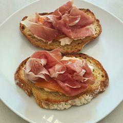 A picture of Bruschetta with burrata melon and prosciutto San Daniele.