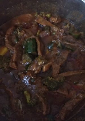 A picture of Beef stew with Broccoli and Zucchini.