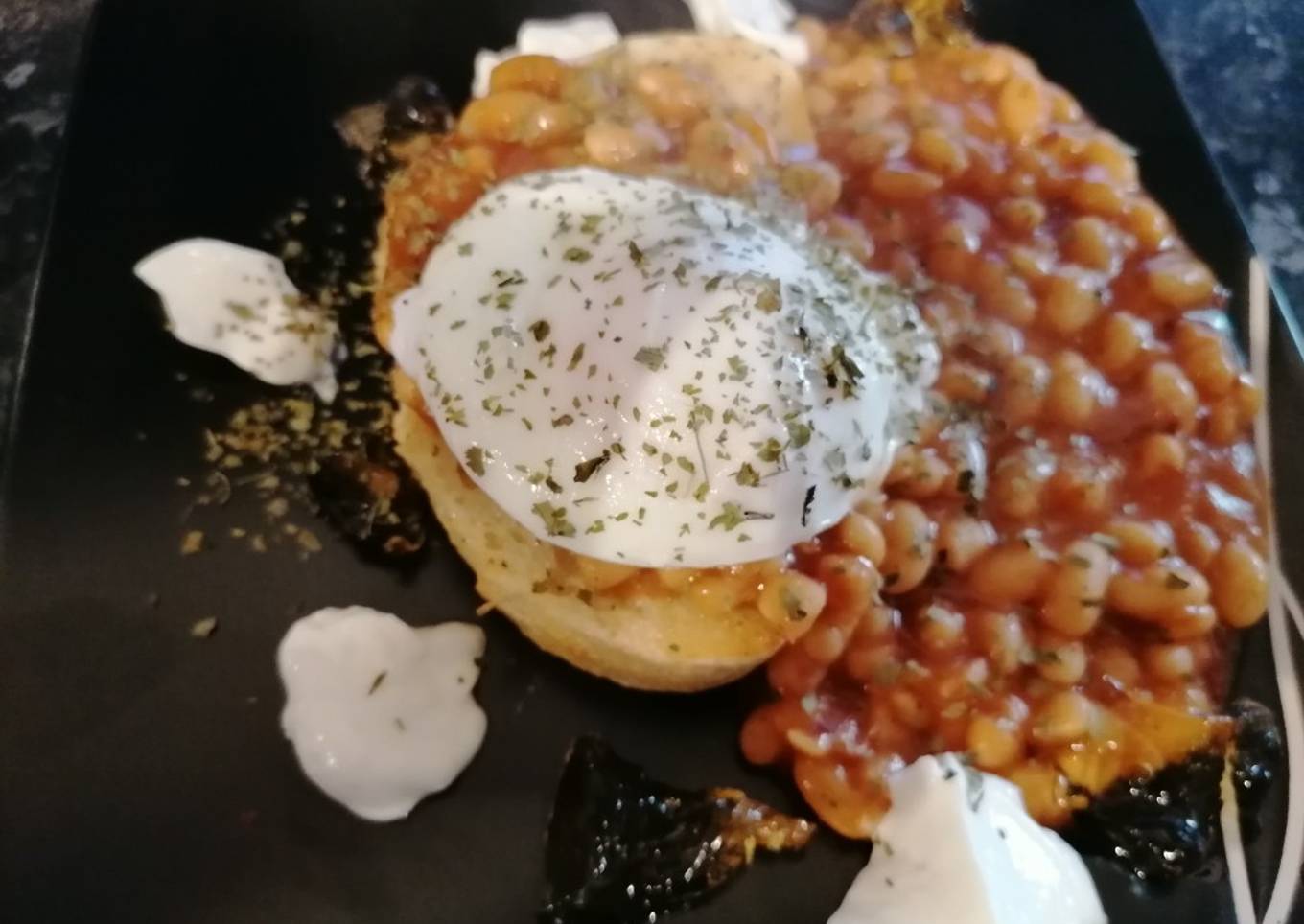 Poached egg, spicy baked beans on toast, marmalade and yoghurt