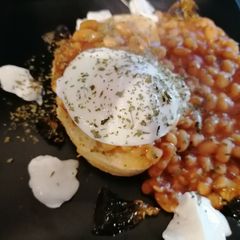 Poached egg, spicy baked beans on toast, marmalade and yoghurt A picture of Poached egg, spicy baked beans on toast, marmalade and yoghurt.