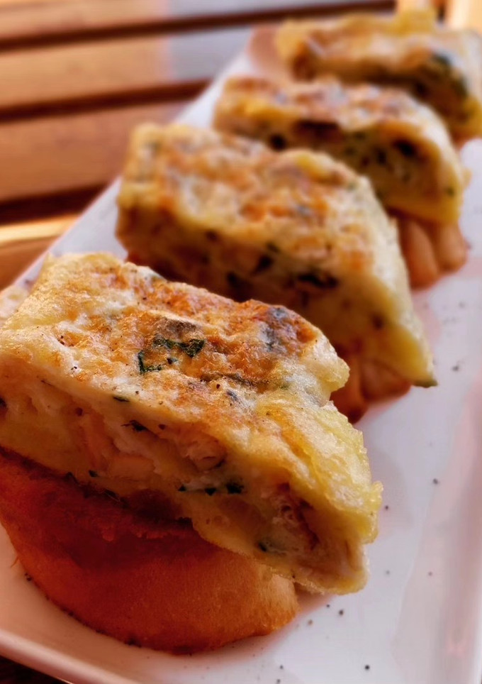 Una foto de Pincho de tortilla de boquerones y ajo asado