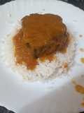 Lomo de cerdo en salsa de papaya y naranja sobre cama de arroz