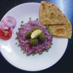 Purple yam curry serve with green kofta A picture of Purple yam curry serve with green kofta.