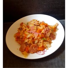 A picture of Scrambled eggs sauce with Sausages.