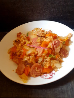 A picture of Scrambled eggs sauce with Sausages.