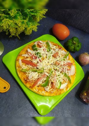 A picture of Veg pizza / ONION tomato CAPSICUM PIZZA.