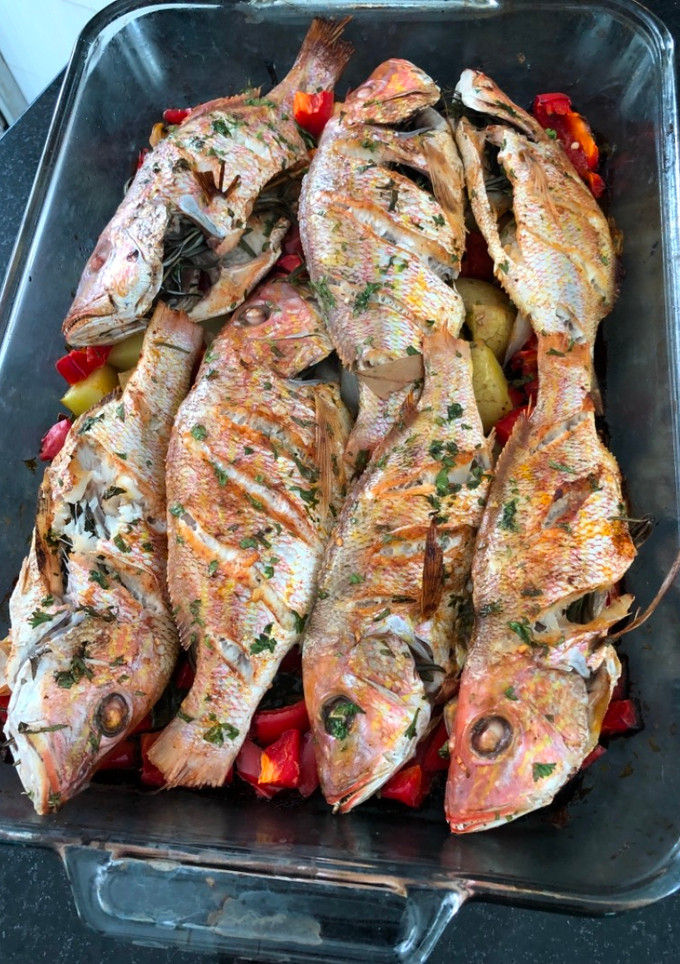 Una foto de Pescado Horneado al Romero en Cama de Vegetales