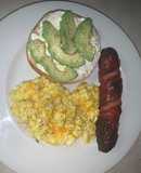 Avocado bagel with cheesy eggs and pineapple smoked sausage