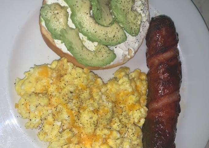 Avocado bagel with cheesy eggs and pineapple smoked sausage