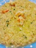 Risotto con riso integrale, crema di porri e code di gamberi