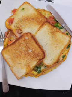 A picture of Bread sliced cheese omelette.