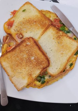 A picture of Bread sliced cheese omelette.