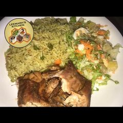 A picture of Fried rice, fried chicken and coeslow.