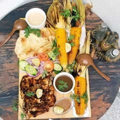 A picture of Bbq tikka with grilled corns.