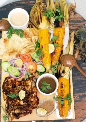 A picture of Bbq tikka with grilled corns.