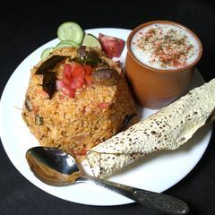 A picture of Tomato Mushroom pulao with spiced buttermilk.