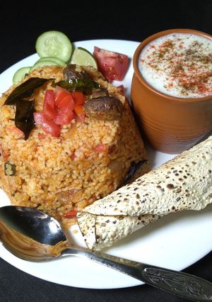 A picture of Tomato Mushroom pulao with spiced buttermilk.