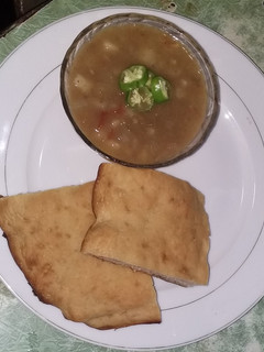 A picture of Spicy potato soup with homemade bread.