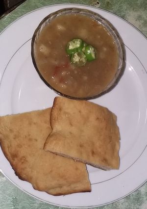A picture of Spicy potato soup with homemade bread.