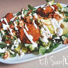 Una foto de Ensalada con mini filetes rusos salsa César y frutos secos