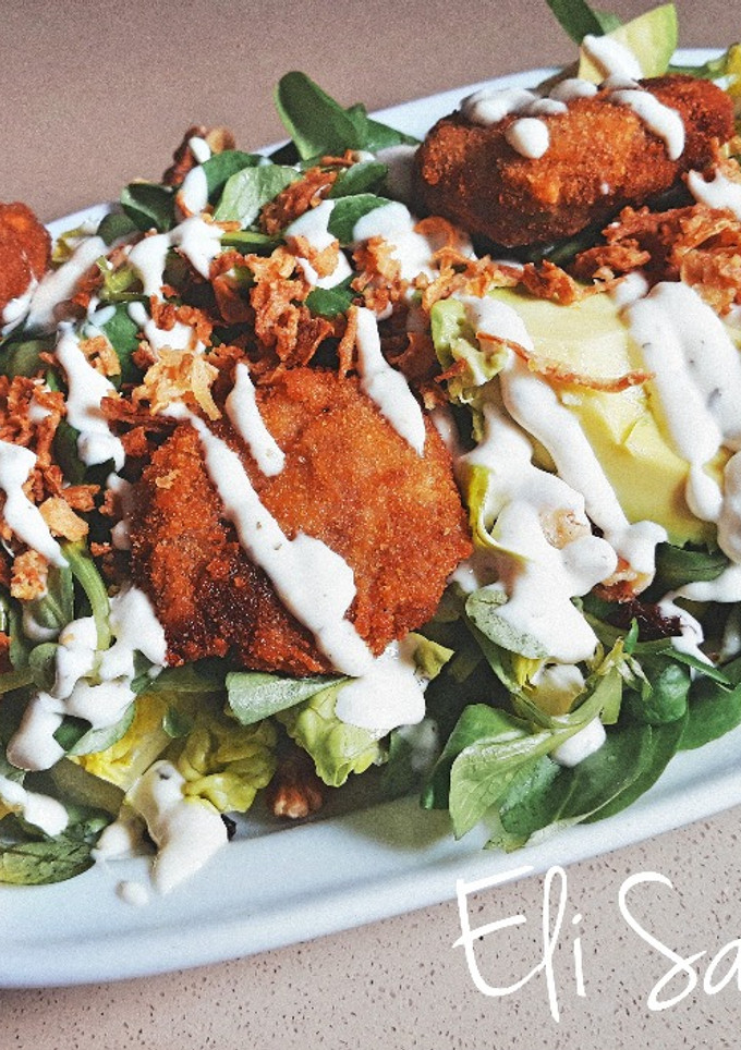 Una foto de Ensalada con mini filetes rusos salsa César y frutos secos