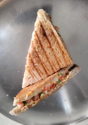 A picture of Cheese, vegetable and mayonnaise grilled sandwich.