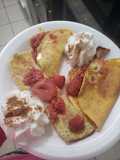 Crepas de coco y proteína acompañado de fresas, y frambuesa