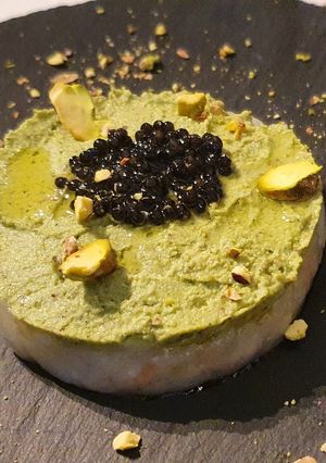 A picture of Scampi Tartare with Broccoli Pistachio Pesto and Caviar.