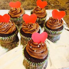 A picture of Chocolate cupcakes with chocolate frosting.