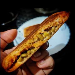 A picture of Green Moong sandwich with leftover green moong sundal.