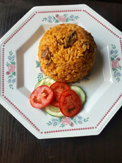 A picture of Jollof rice with dried fish.